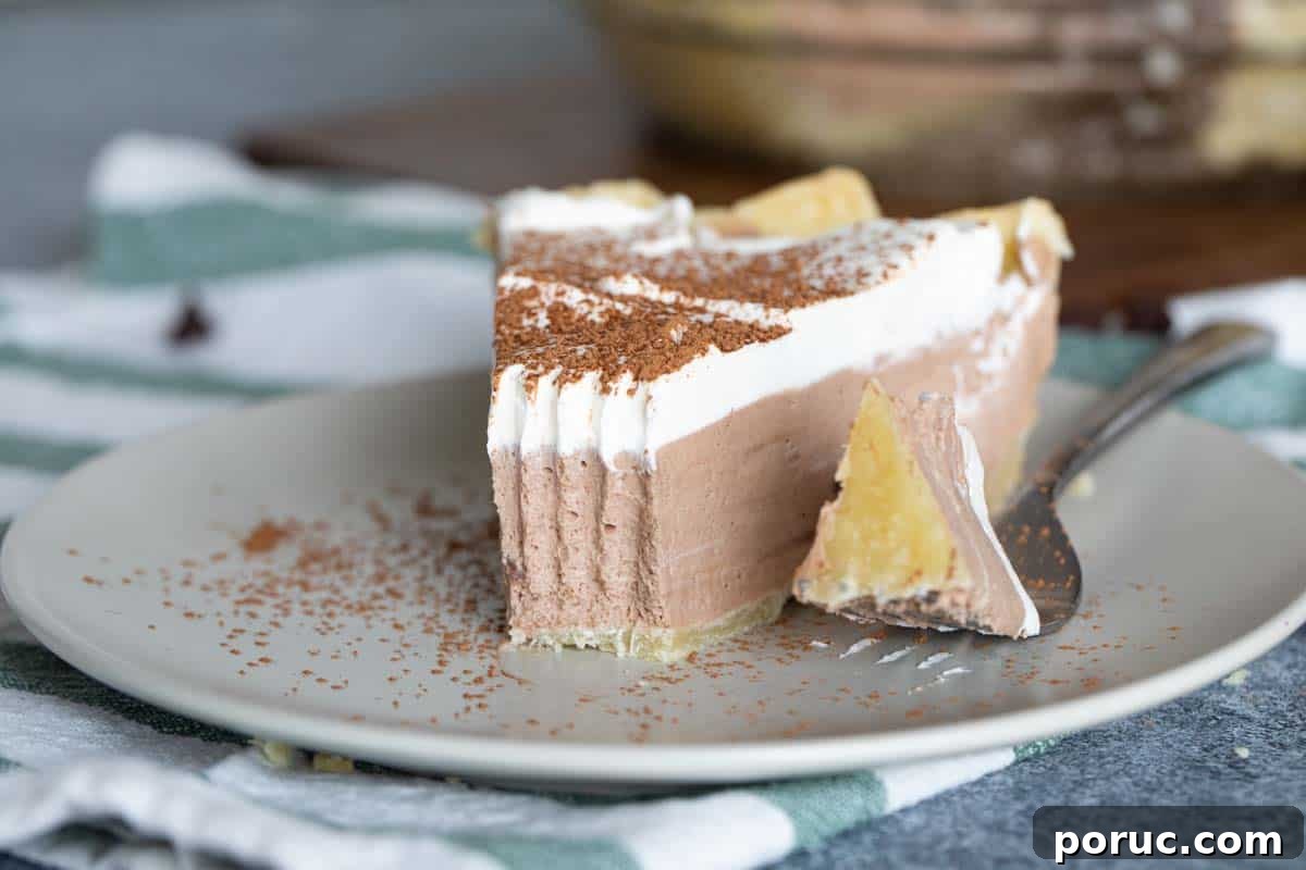 Rich, creamy and silky, this Chocolate Cream Pie is a chocolate lovers dream! A creamy chocolate filling is topped with whipped cream in this easy, crowd pleasing pie. slice of chocolate cream pie with bite taken from it