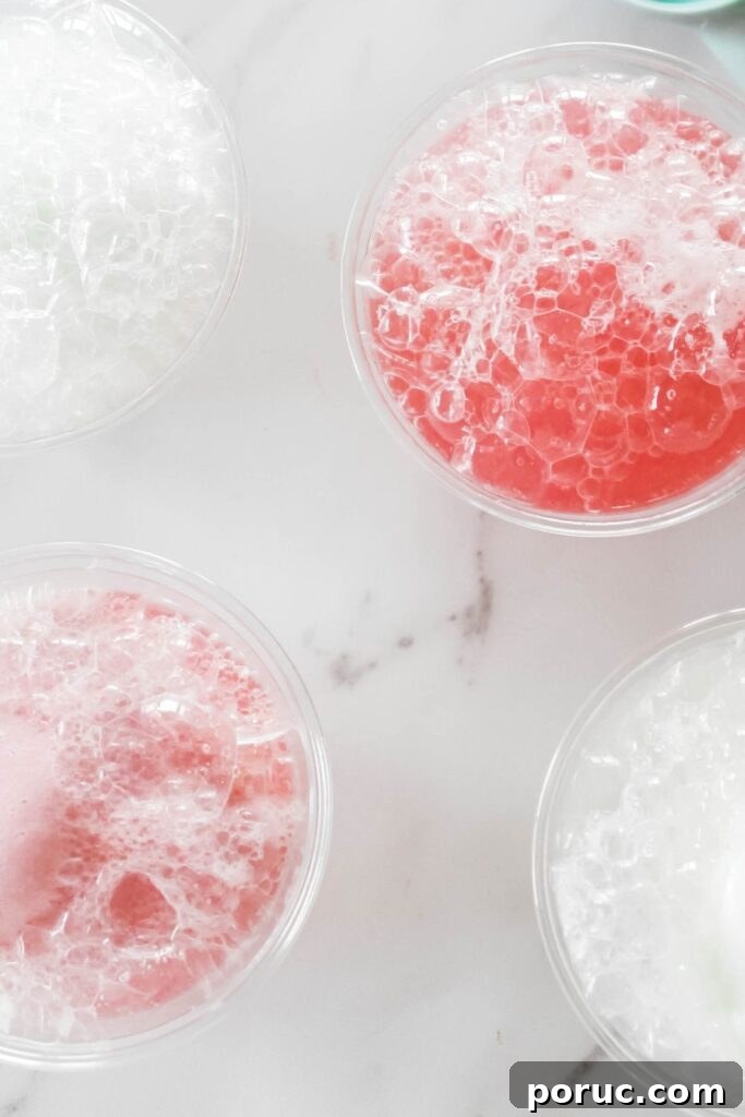 Gumdrops & Sherbet Party Punch Recipe 4 glasses with sherbet and pop poured into them on marble counter