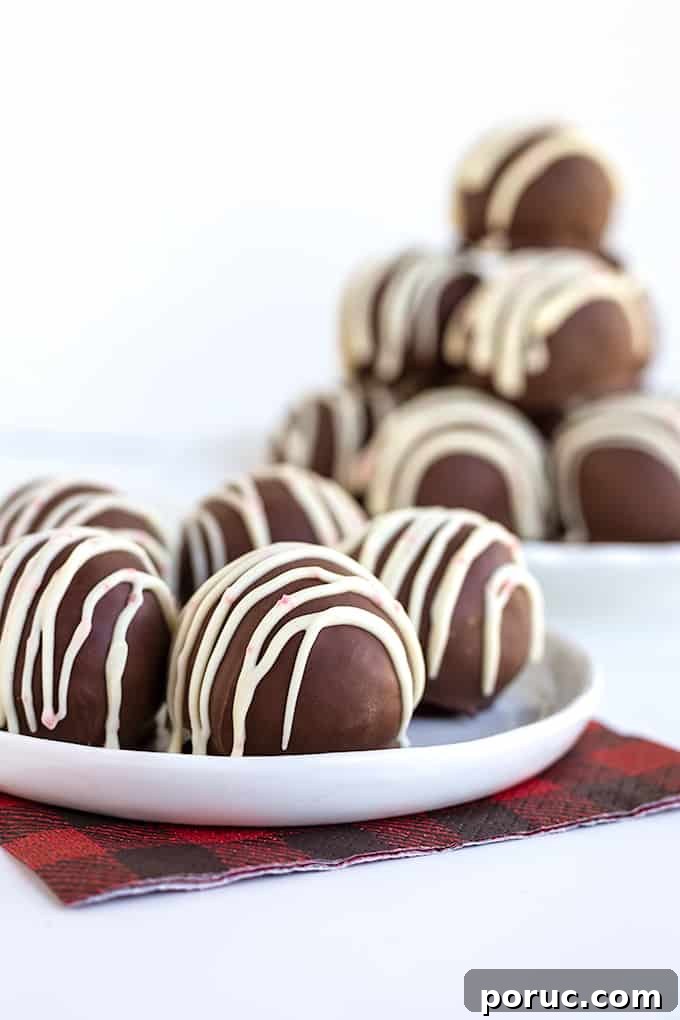 Peppermint cookie truffles on a white plate with a red and black napkin on a white surface