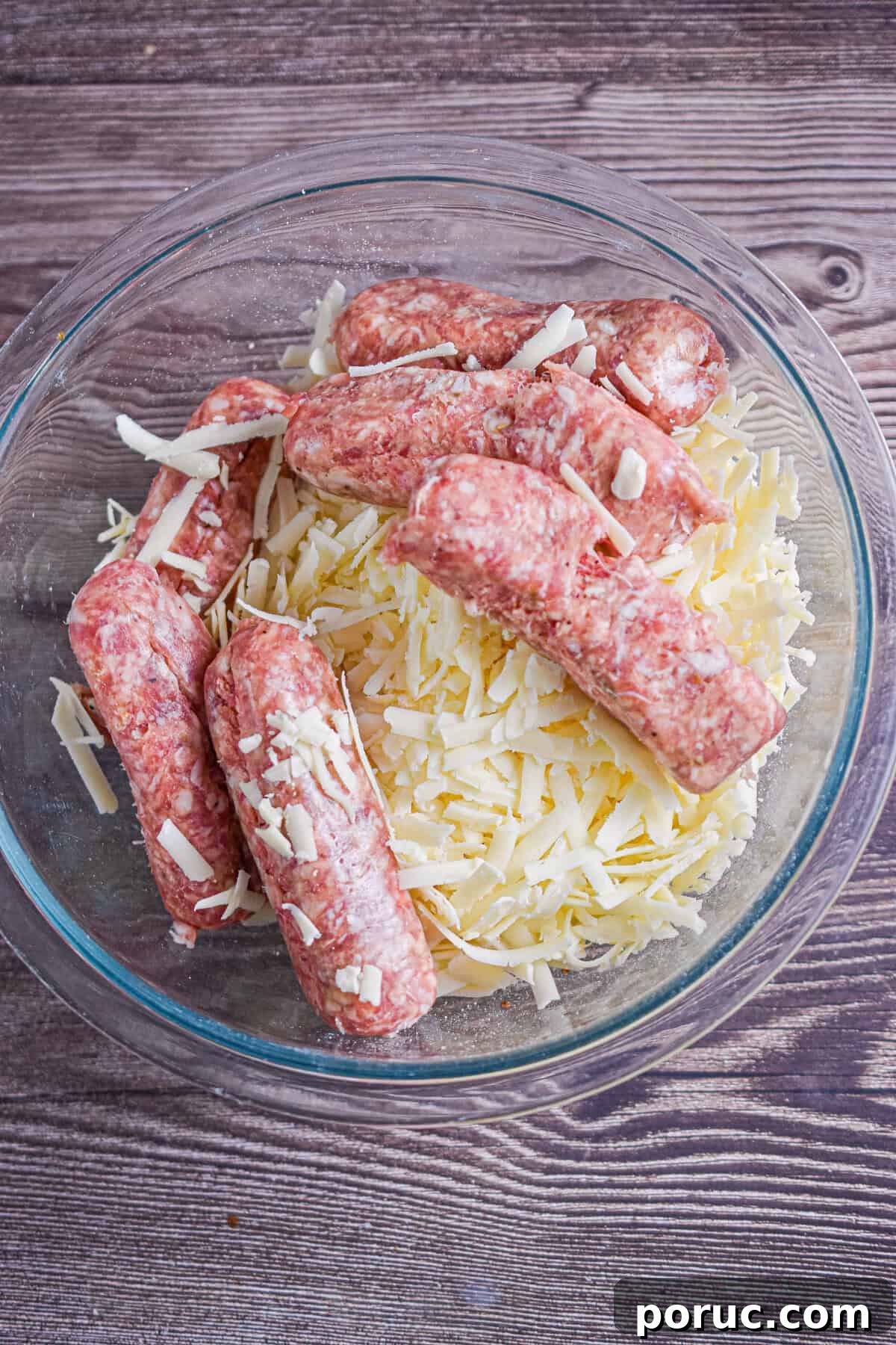 Cheesy Sausage Balls with 3 Ingredients: Quick Party Appetizer 4 The sausage, Bisquick, and shredded cheese are added to a mixing bowl.