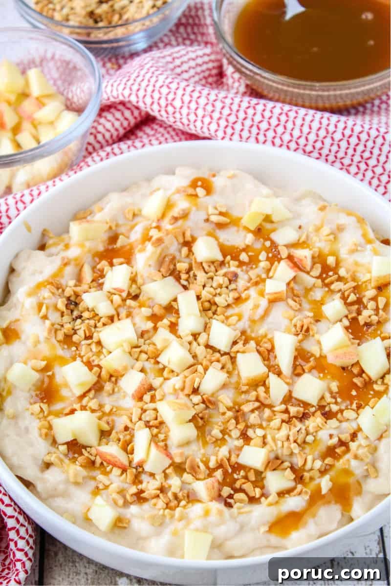 Get all the Fall feels with this 5-minute Caramel Apple Cheesecake Dip! Crazy easy to make and perfect for sharing! cheesecake dip topped with caramel sauce, chopped nuts, and diced apples