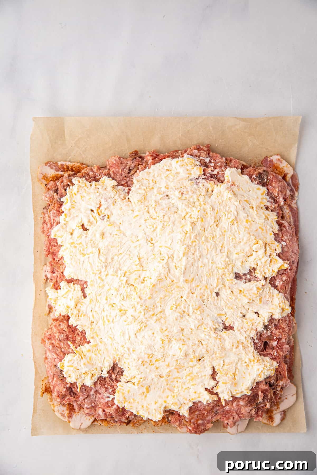 Ultimate Bacon Explosion Recipe: Stuffed Bacon-Wrapped Meatloaf 9 Spreading cheese mixture over bacon weave and pork mixture for Bacon Explosion