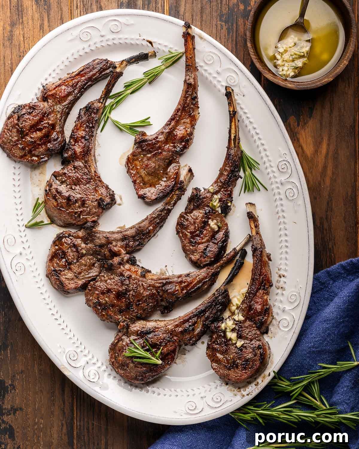 Lemon Garlic Grilled Lamb Rib Chops Recipe for Juicy Flavor 2 Platter of grilled lamb rib chops with bowl of lemon garlic sauce on the side.
