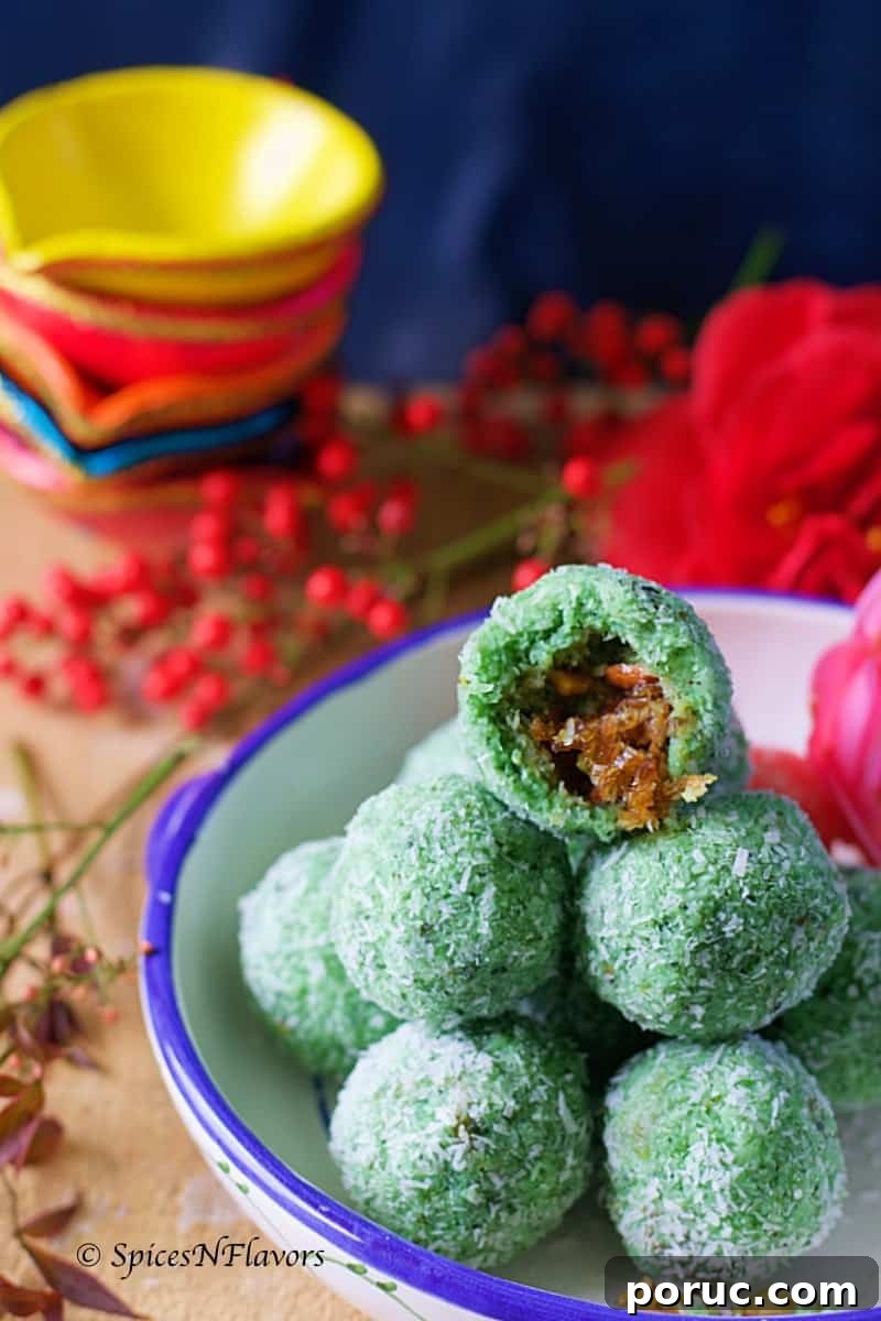 Paan Coconut Ladoo Recipe: How to Make Minty Indian Sweets 6 half portion of the laddu showing the texture and the filling inside placed on top of few other ladoos