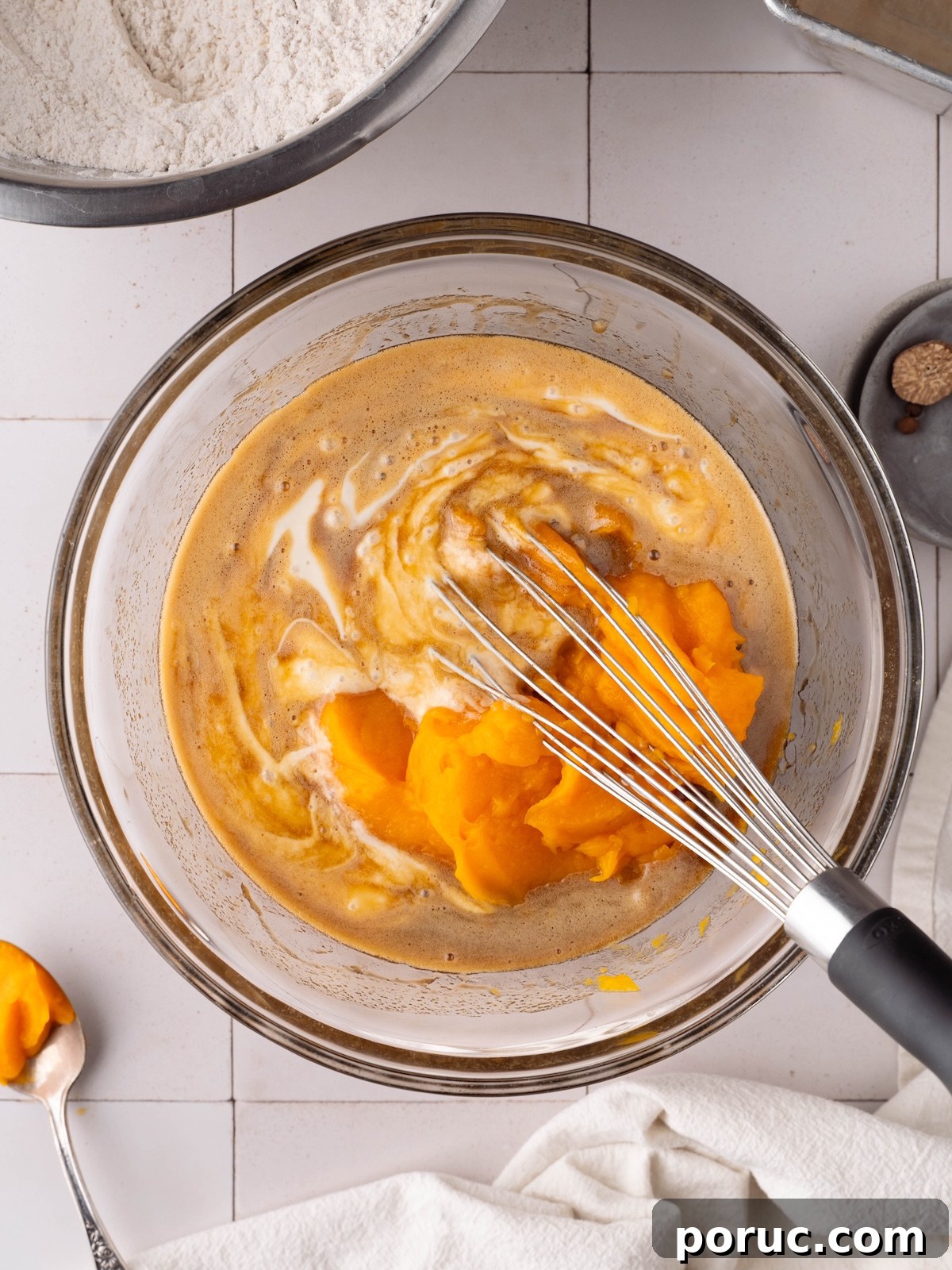 Whisking together pumpkin puree, sourdough discard, and other wet ingredients for a quick bread