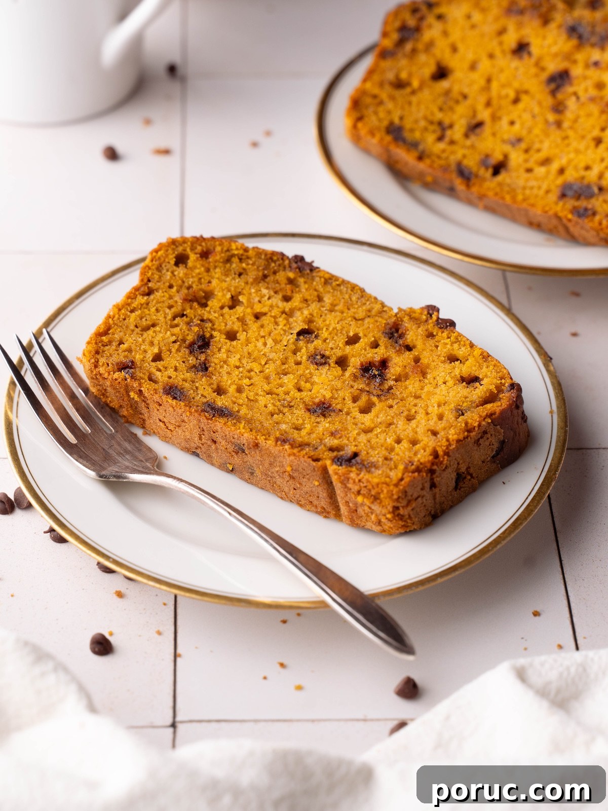 Slices of chocolate chip sourdough pumpkin bread on plates