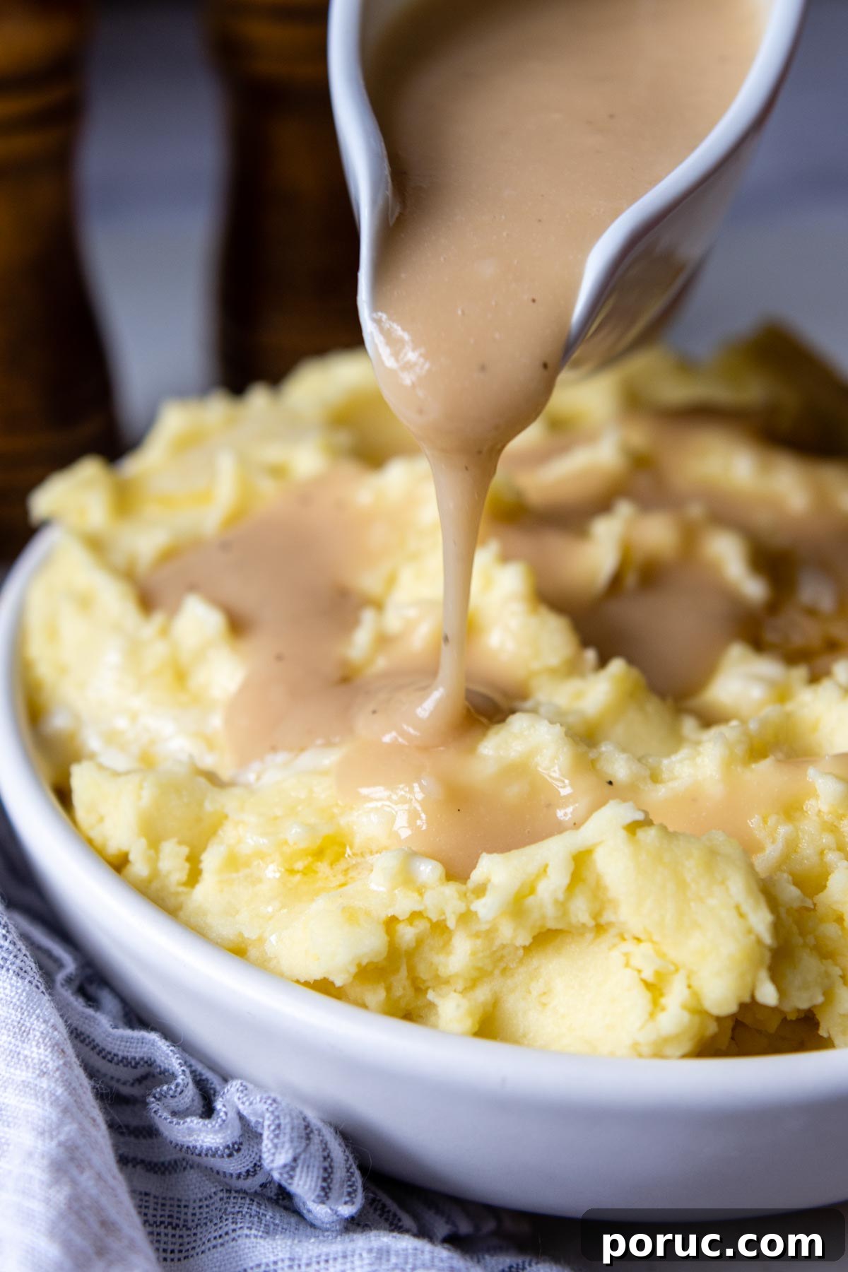 Velvety Gluten-Free Gravy Without Pan Drippings — Thickener Tips 10 gluten free gravy being poured over mashed potatoes.