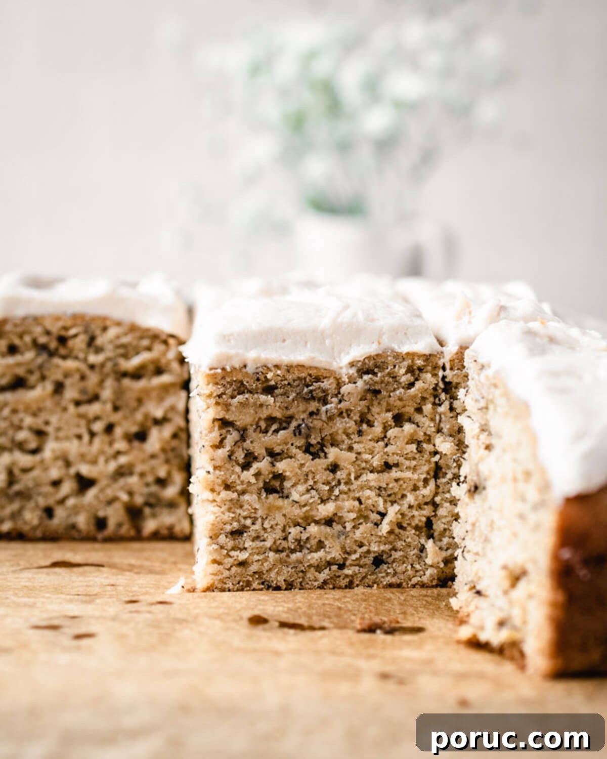 Moist Banana Snack Cake Recipe for Quick Homemade Treat 2 Cross section of banana snack cake with frosting.