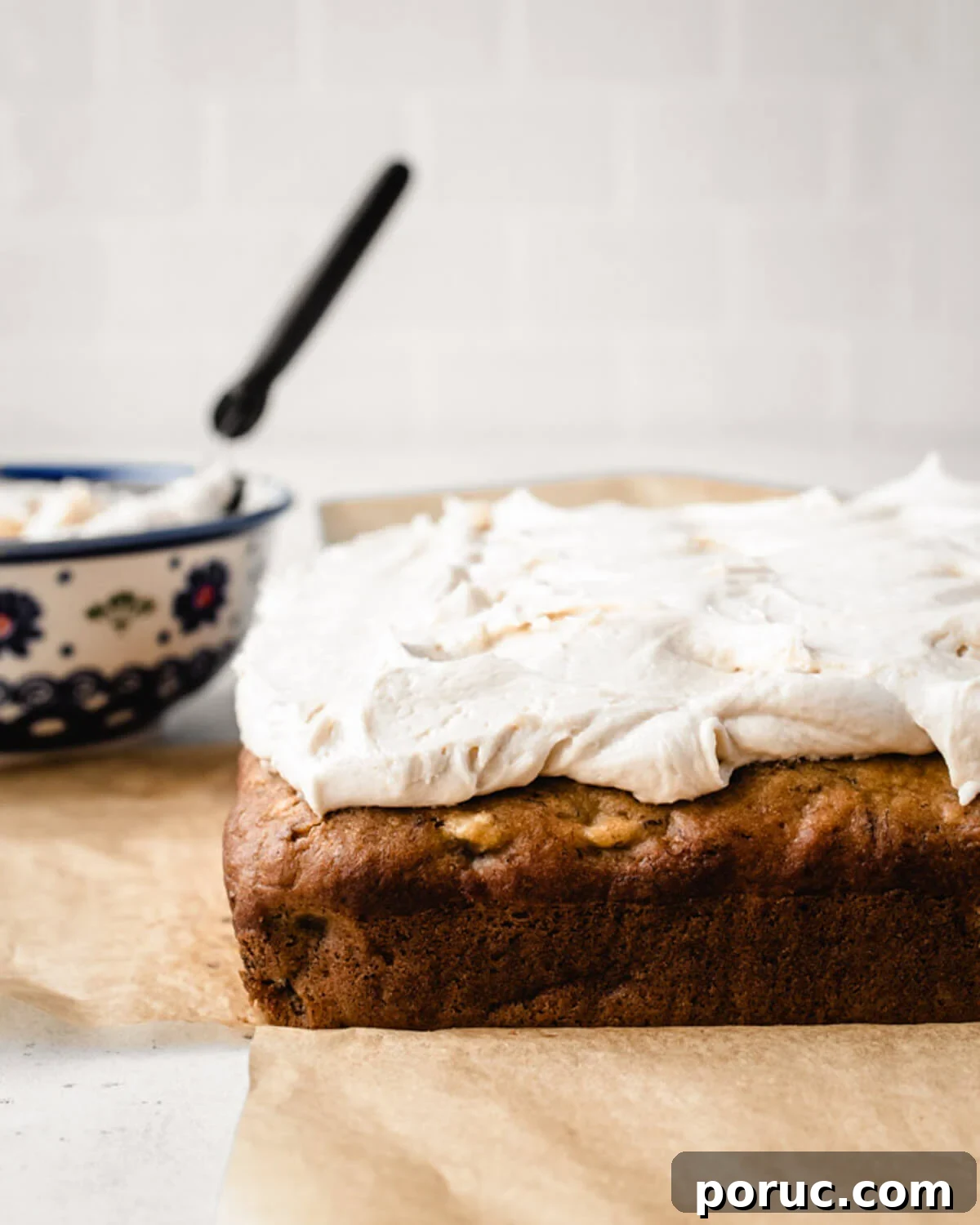 Moist Banana Snack Cake Recipe for Quick Homemade Treat 3 Banana Snack Cake with salted caramel frosting waiting to be cut into squares.