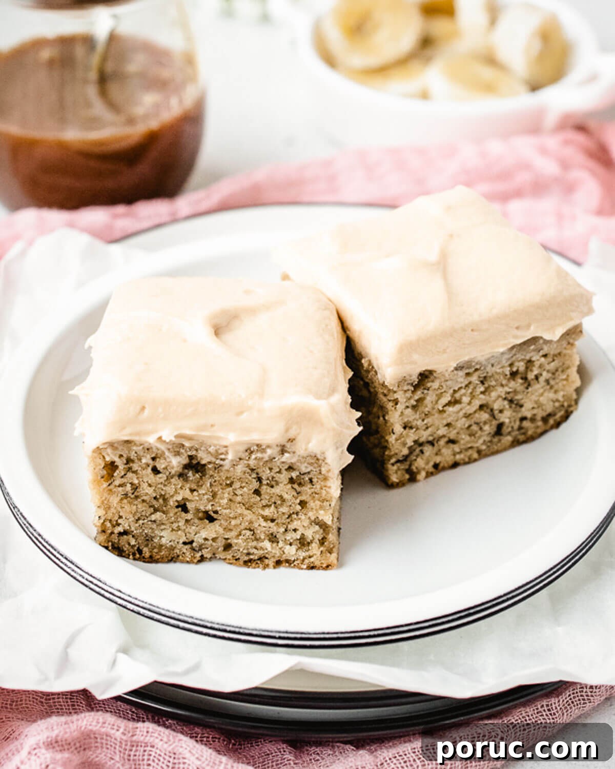 Moist Banana Snack Cake Recipe for Quick Homemade Treat 8 Two square pieces of banana cake on a plate.