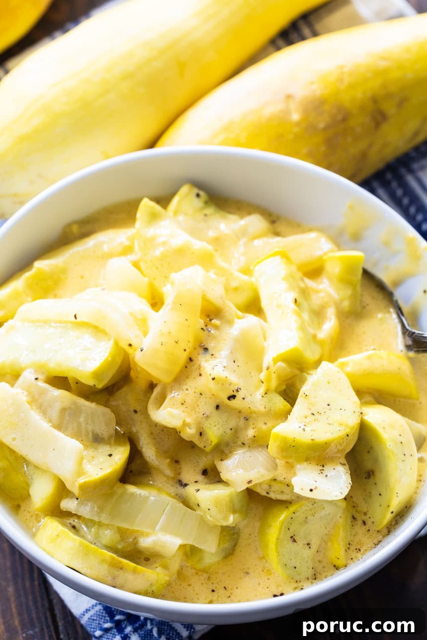 Cheesy Slow Cooker Squash Casserole Recipe 4 Cheesy Yellow Squash in a white bowl with squash in the background