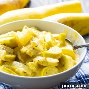 Cheesy Slow Cooker Squash Casserole Recipe 5 Cheesy Squash in a white bowl with yellow squash in the background.