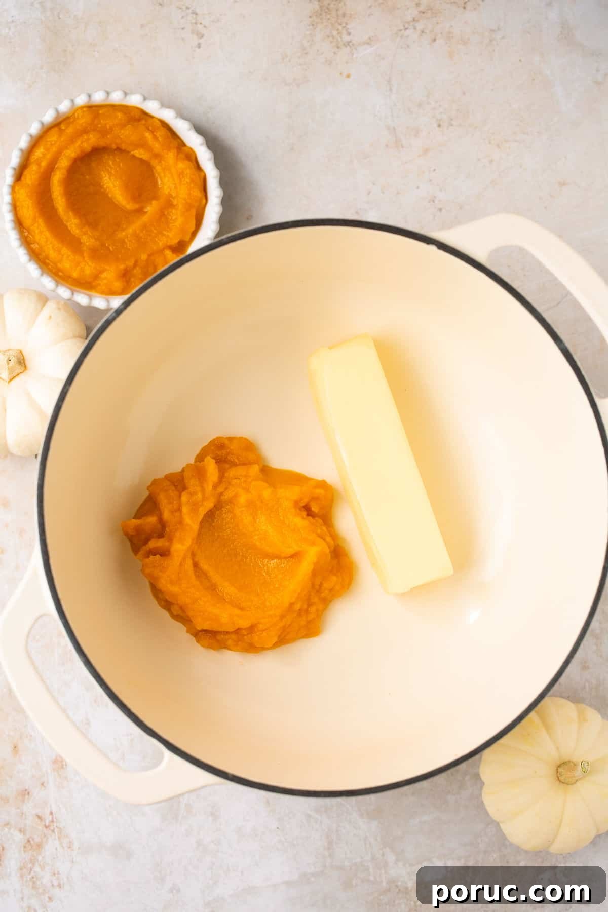 Pumpkin Marshmallow Rice Krispie Treats for Fall Parties 4 A pot with pumpkin puree and a stick of butter in it.