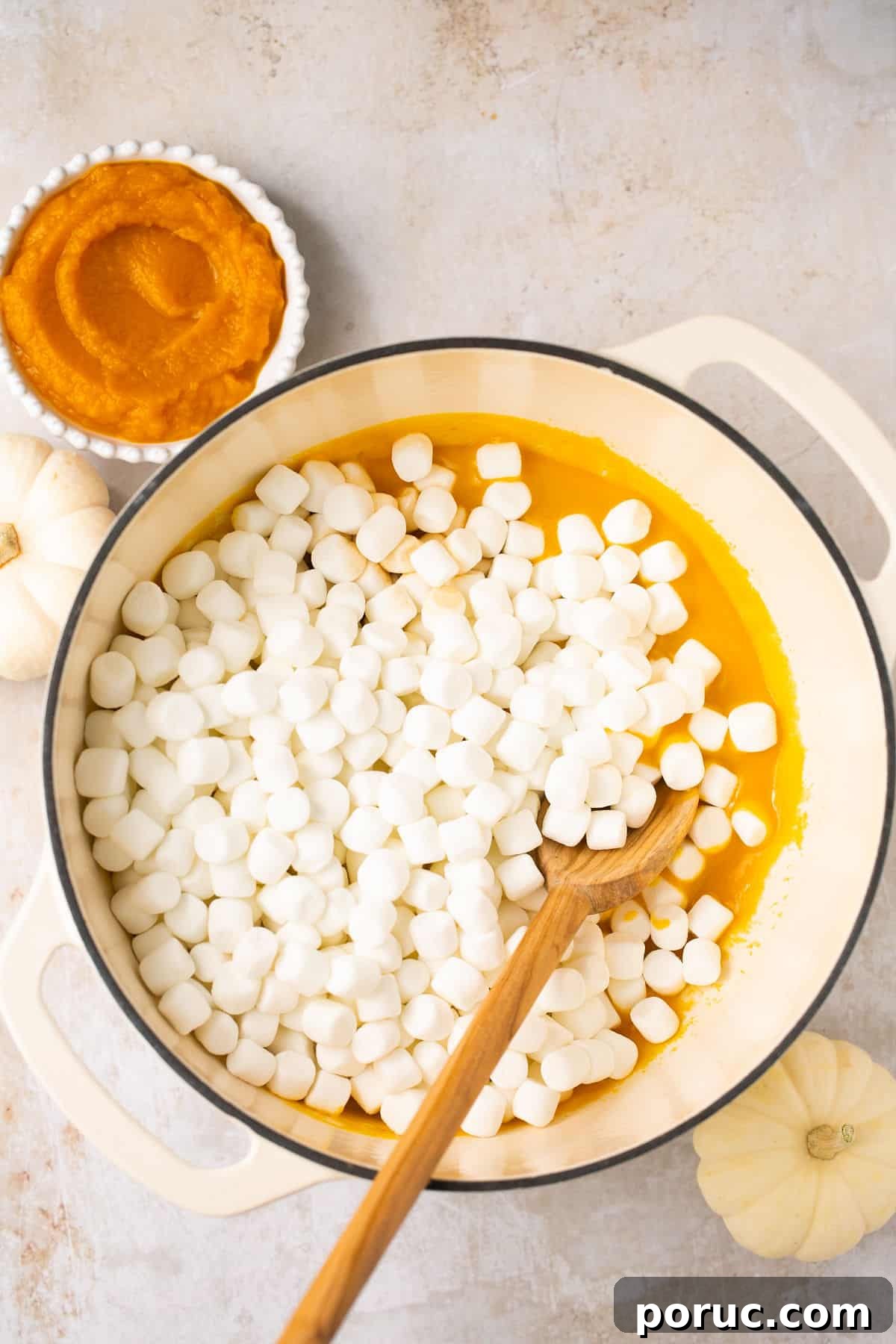 Pumpkin Marshmallow Rice Krispie Treats for Fall Parties 5 A pot with melted pumpkin puree and butter with mini marshmallows on top.