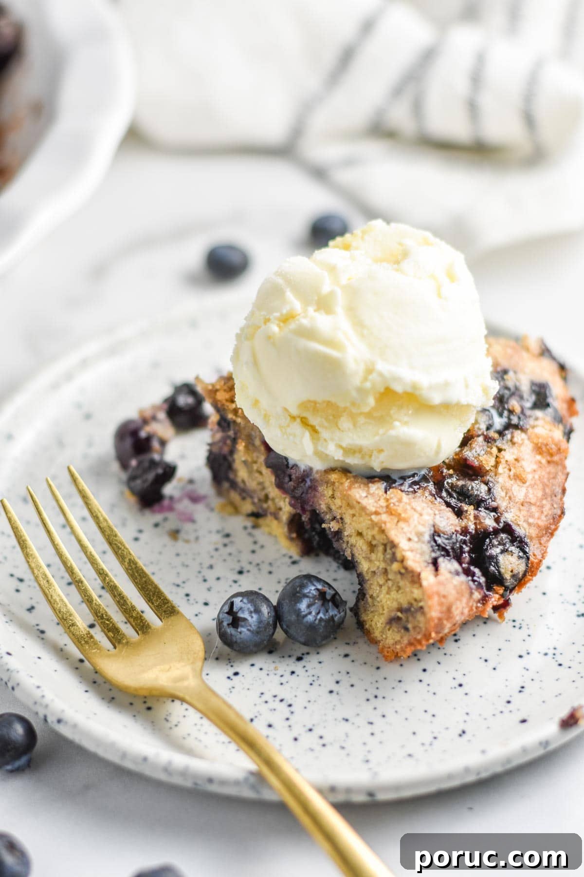 Crustless Blueberry Pie Recipe: Quick, Creamy Summer Dessert 11 A slice of an impossible blueberry pie on a plate.
