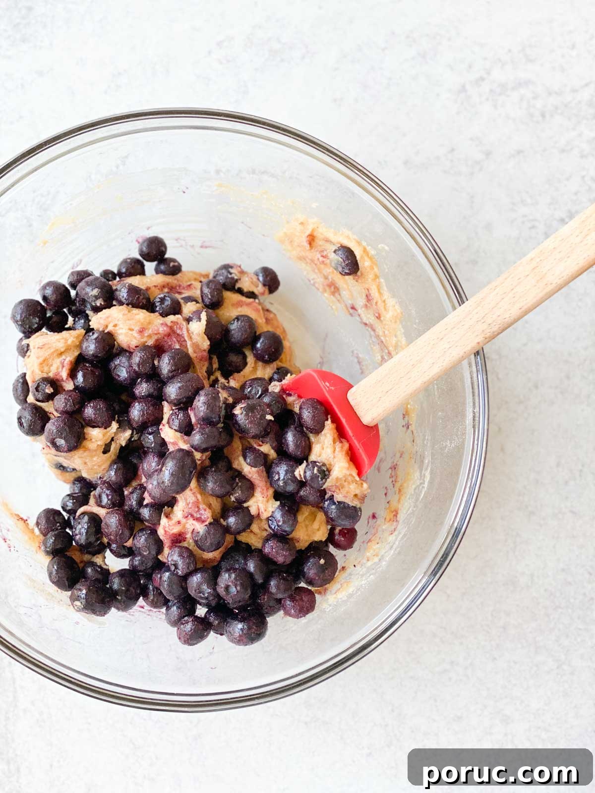 Crustless Blueberry Pie Recipe: Quick, Creamy Summer Dessert 7 Stirring frozen blueberries into dough.