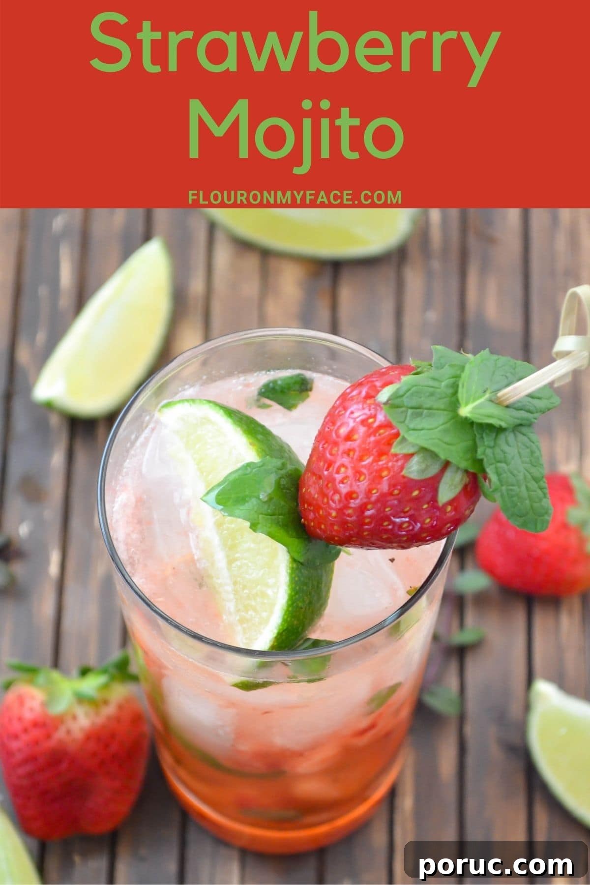 Tall glass filled with Strawberry Mojito garnished with a strawberry, lime wedge and mint.