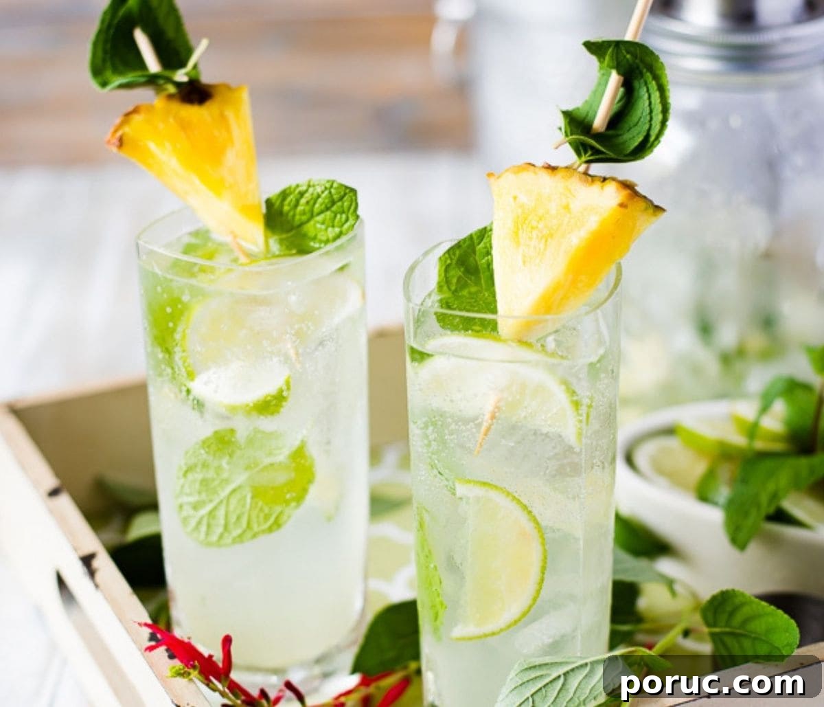 Mojito cocktails on a wooden serving tray.