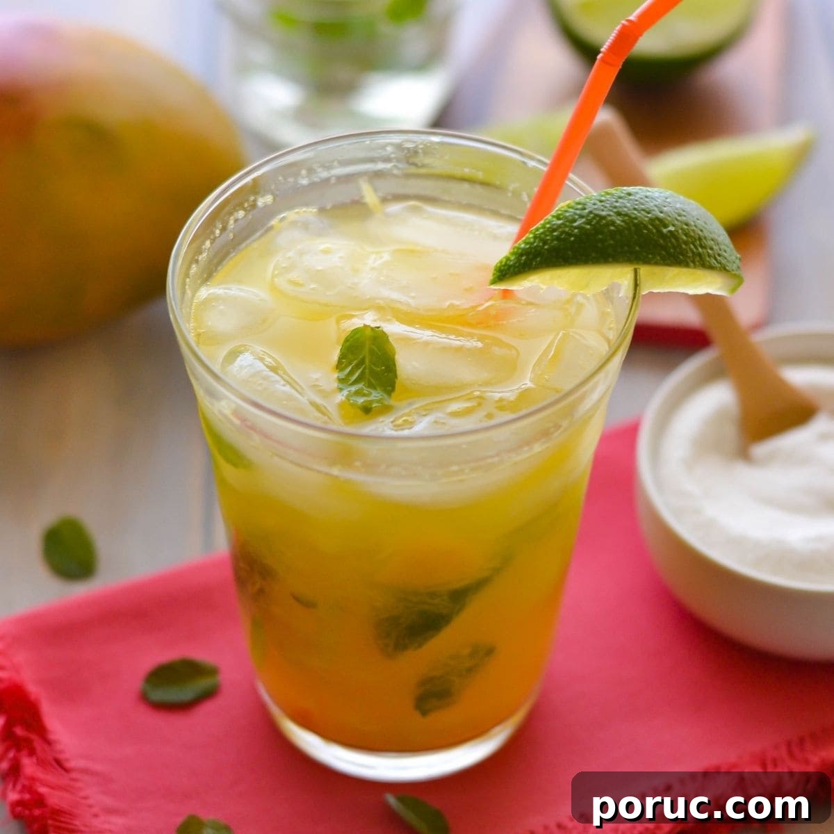 Mango Mojito in a tall glass with a straw.