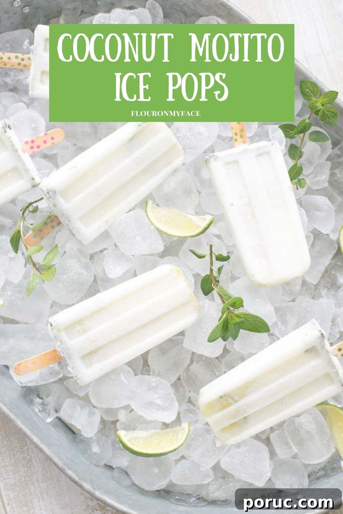 A galvanized serving tray piled high with ice cubes with coconut mojito ice pops nestled in the ice.