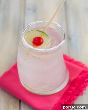 Coconut Rum Cobbler cocktail served in a highball glass with cherry and lime garnish.