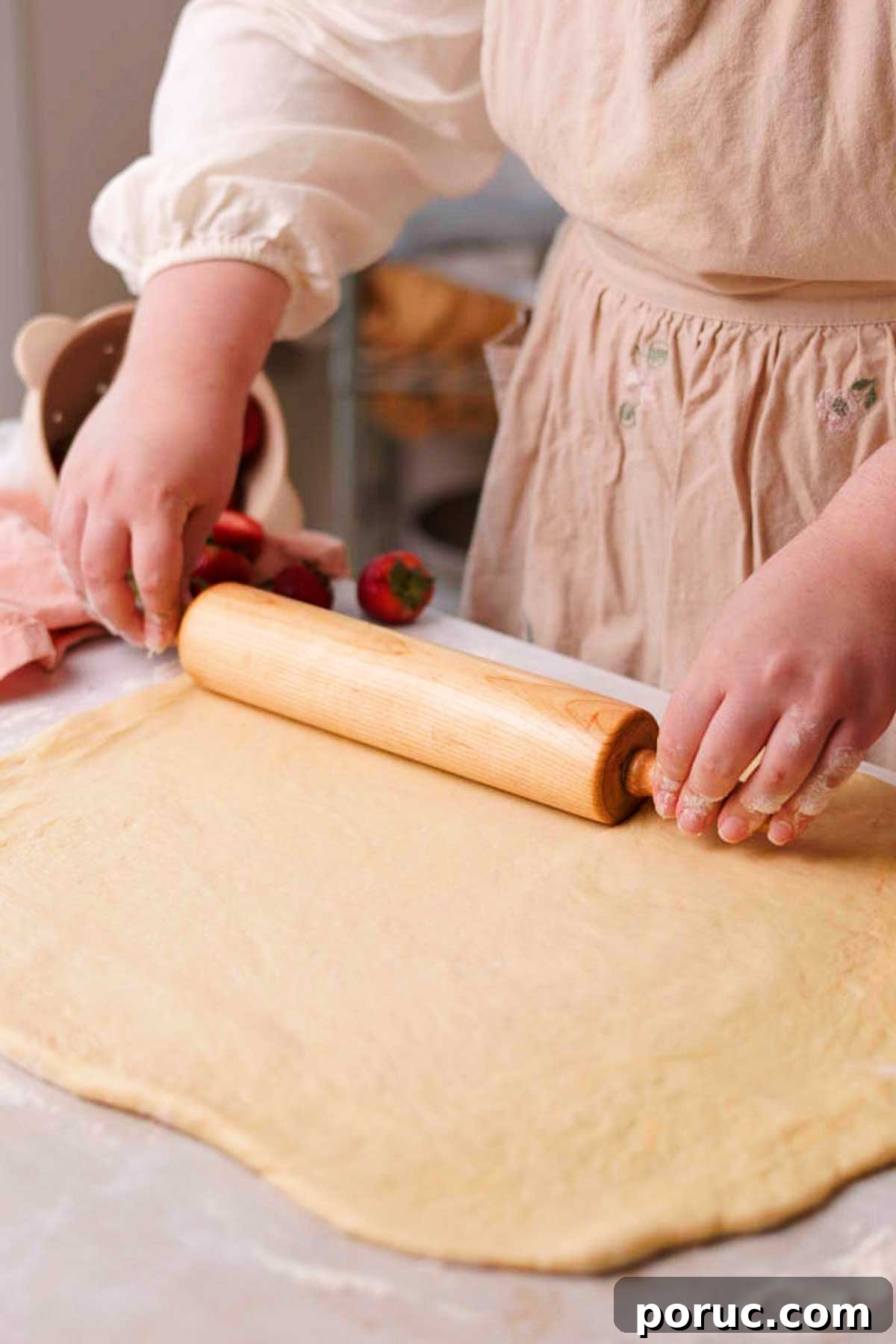 Strawberry Cinnamon Roll Recipe — Soft, Sweet, Homemade Treat 12 rolling out dough on a lightly floured surface with a rolling pin