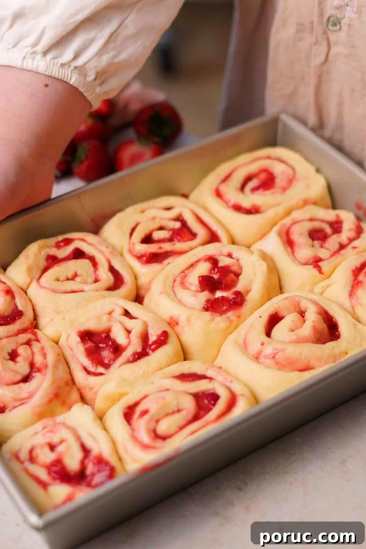 Strawberry Cinnamon Roll Recipe — Soft, Sweet, Homemade Treat 16 risen strawberry cinnamon rolls in rectangular baking pan