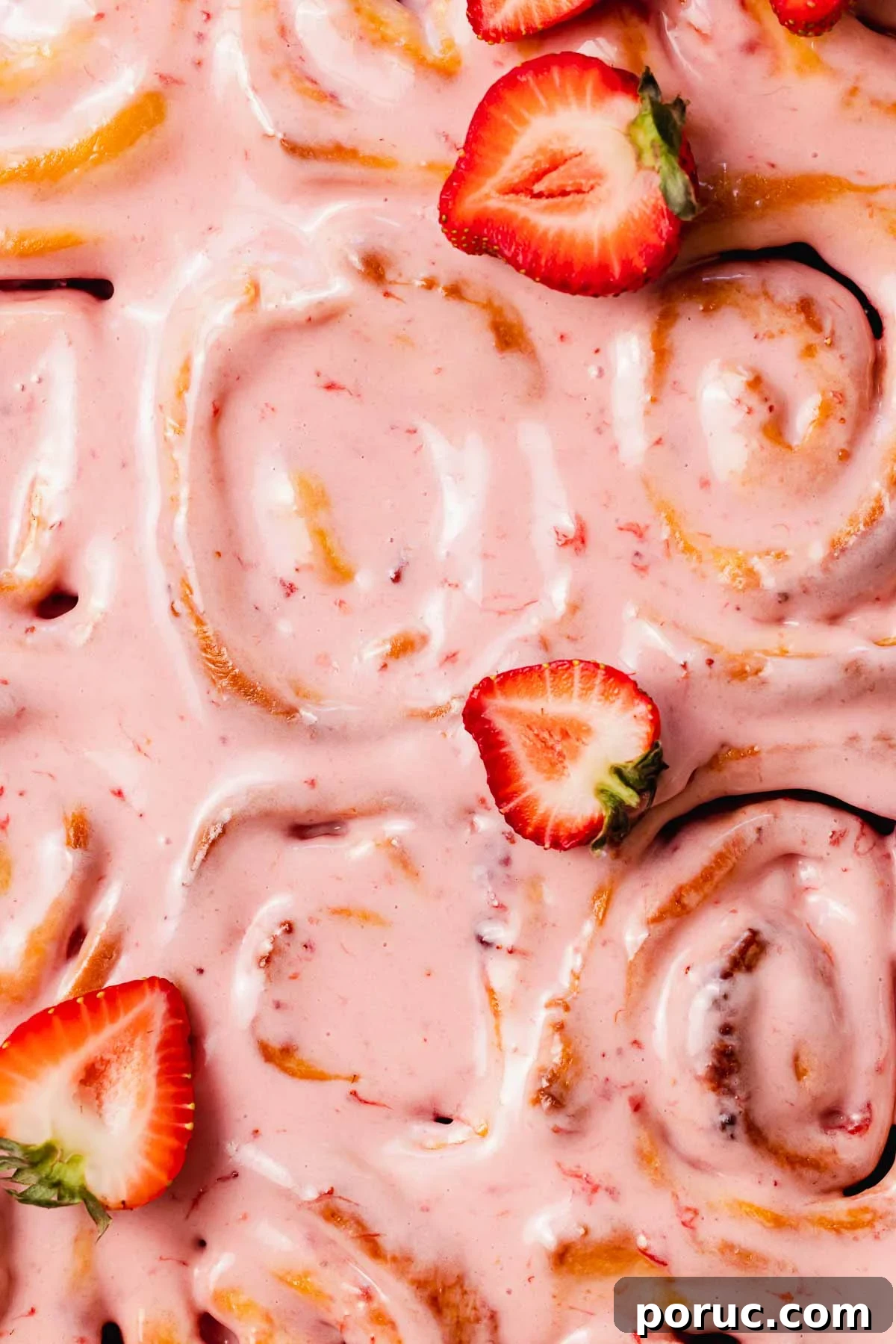 Strawberry Cinnamon Roll Recipe — Soft, Sweet, Homemade Treat 21 closeup of the strawberry cream cheese glaze on top of strawberry cinnamon rolls