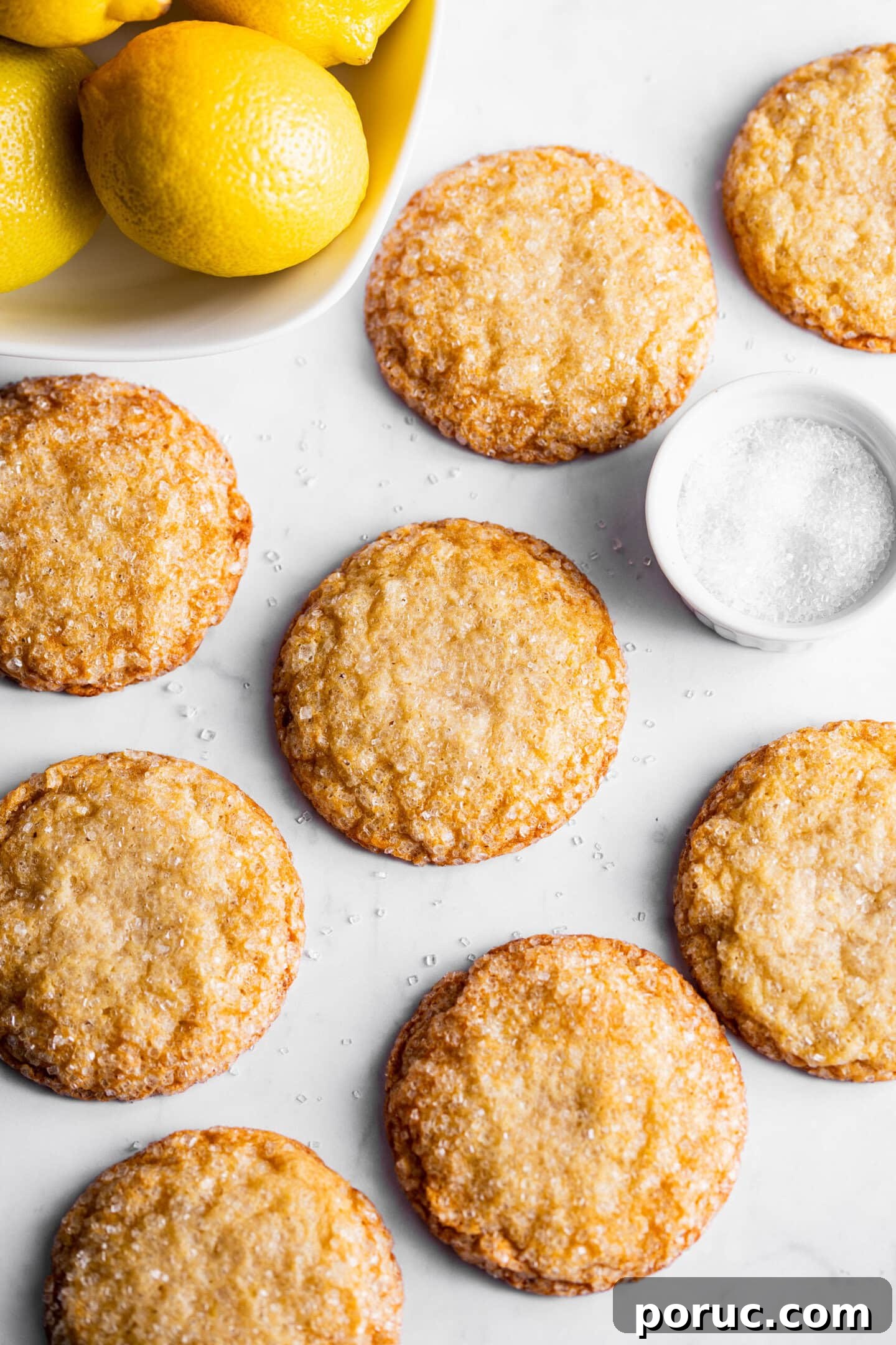 Elegant Lemon Sugar Cookies with Minimal Effort 9 Freshly baked lemon sugar cookies next to a bowl of lemons