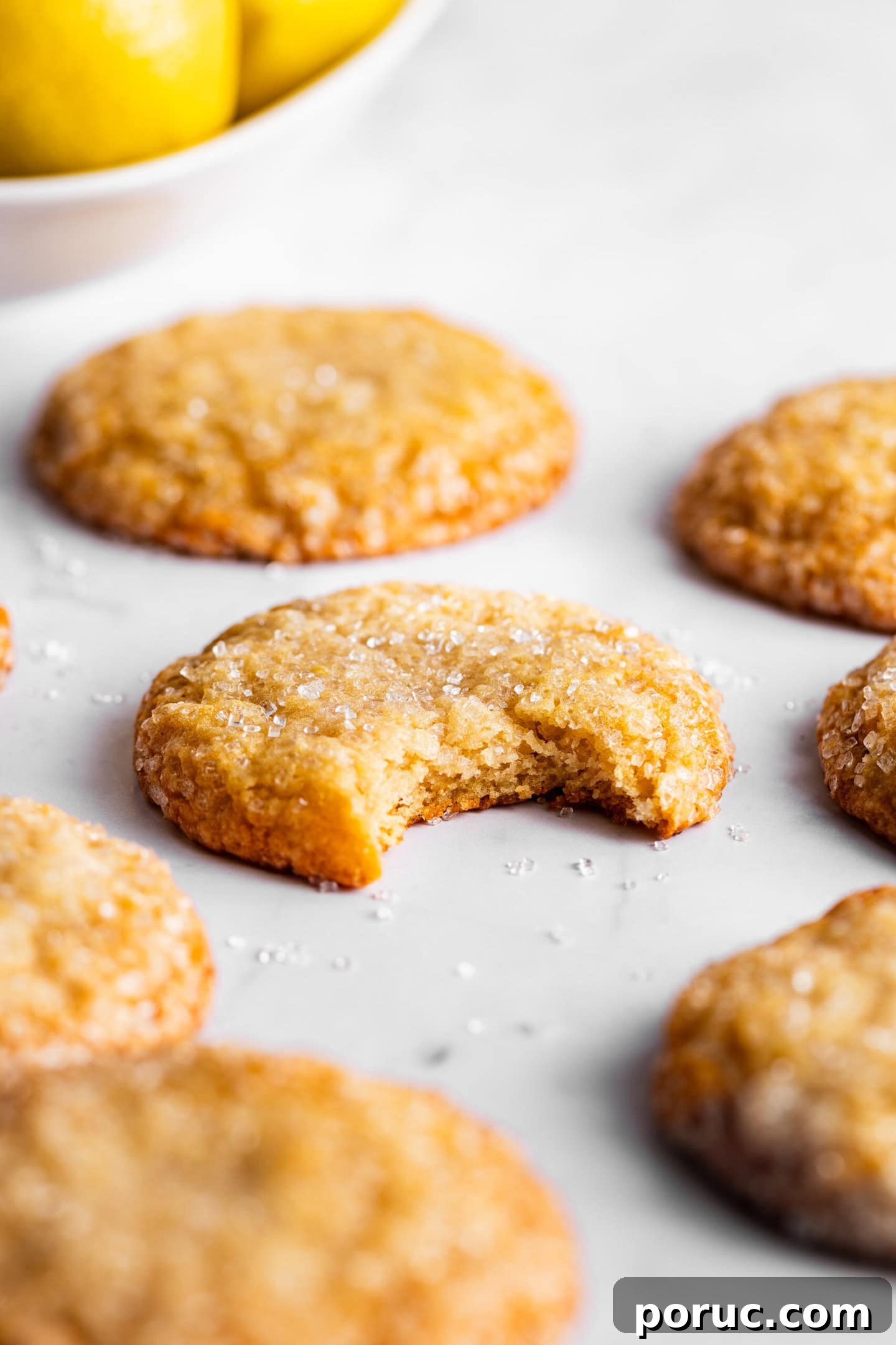 Elegant Lemon Sugar Cookies with Minimal Effort 10 Close up of lemon sugar cookie with a bite missing showing off soft and chewy texture