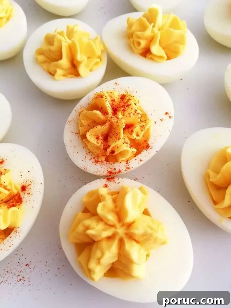 Classic Southern Deviled Eggs Recipe for Gatherings 2 deviled eggs close up of egg with paprika on top