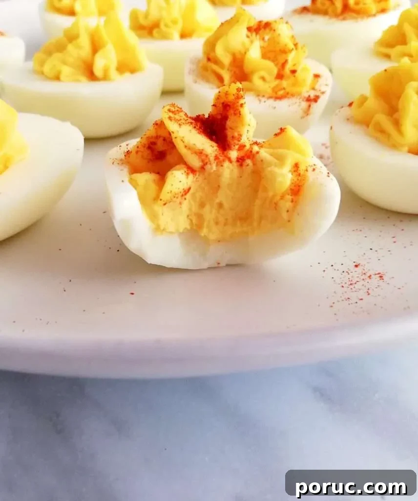 Classic Southern Deviled Eggs Recipe for Gatherings 4 deviled eggs bitten close up
