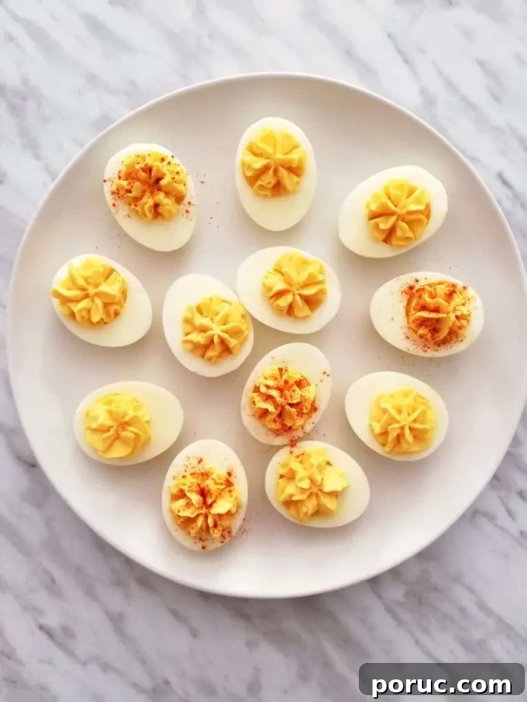 Classic Southern Deviled Eggs Recipe for Gatherings 6 deviled eggs on plate with some eggs topped with paprika