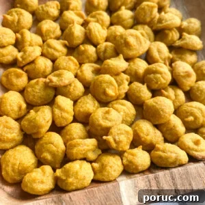 Homemade Pumpkin Baby Puffs: Soft Finger Food for Infants 6 Pumpkin puffs served on a wooden plate