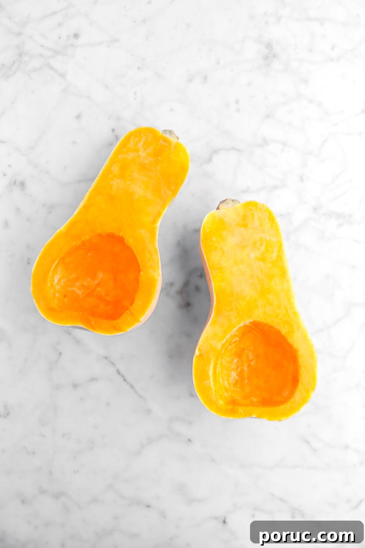 Creamy Roasted Butternut Squash Risotto Recipe 6 halved butternut squash on marble surface.