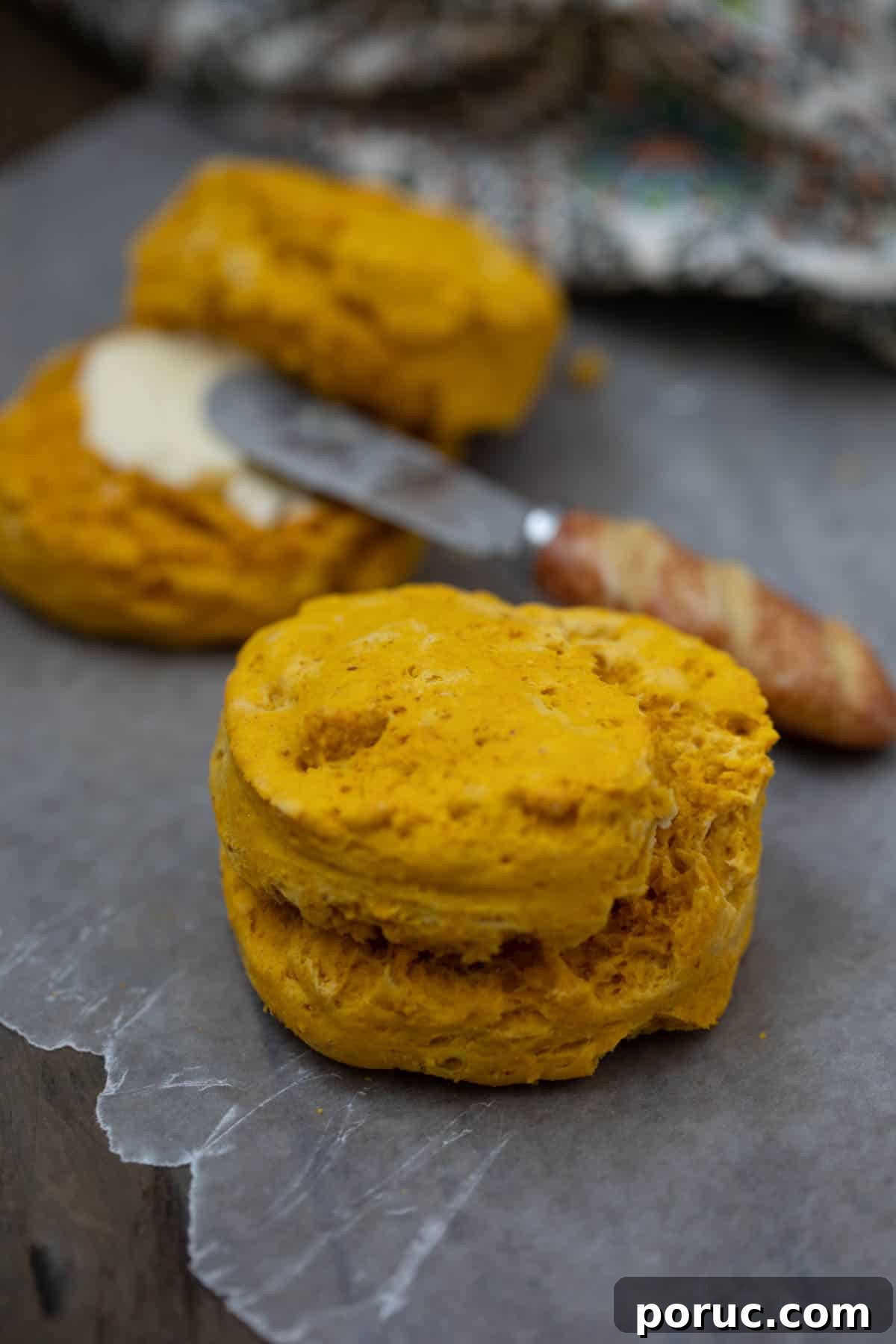 Sweet Potato Biscuit on wax paper next to biscuit with butter