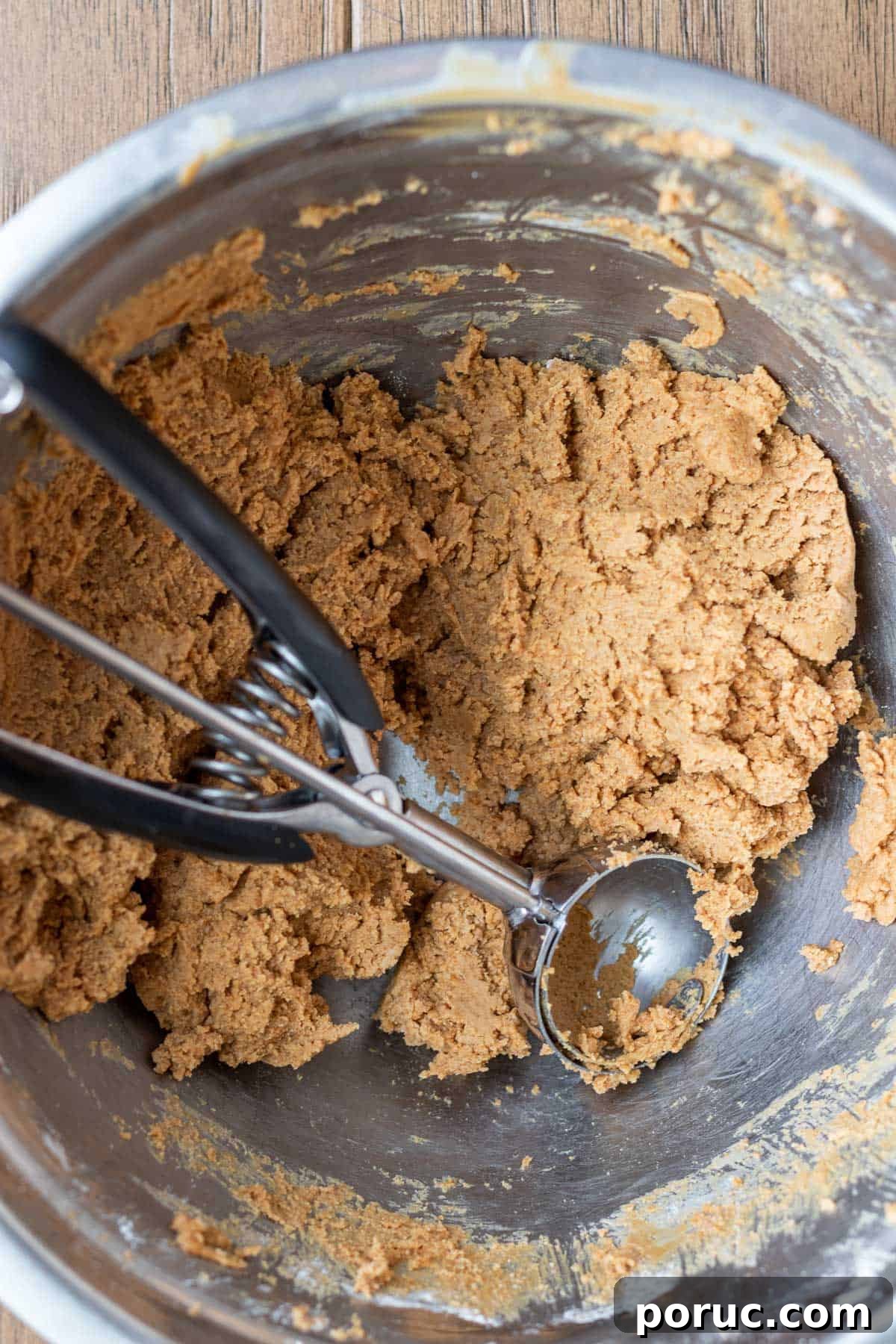 Decadent Biscoff Truffles Recipe: No-Bake Chocolate Treats 4 biscoff truffle batter in a bowl with a cookie scoop in it