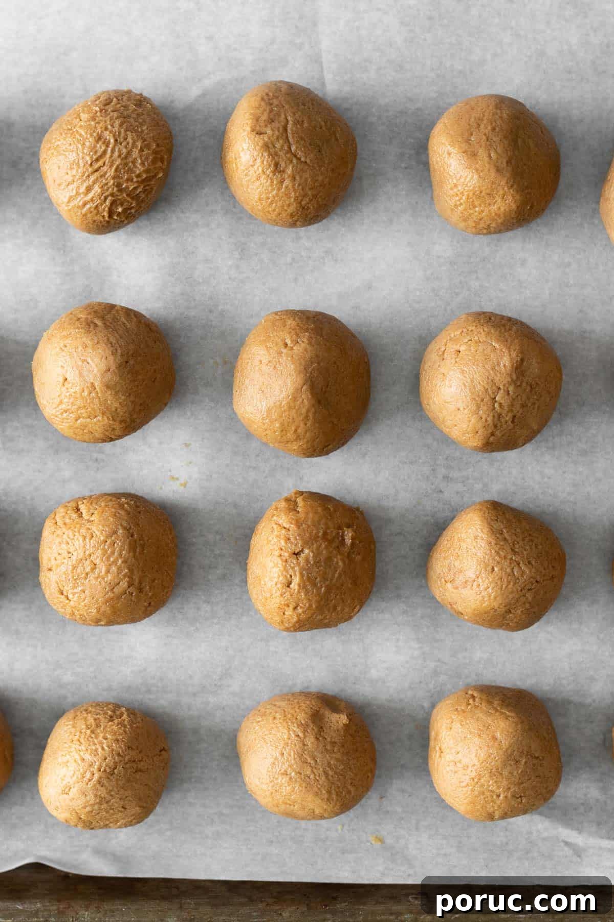 Decadent Biscoff Truffles Recipe: No-Bake Chocolate Treats 5 biscoff truffles rolled into balls and sitting on a parchment lined cookie sheet