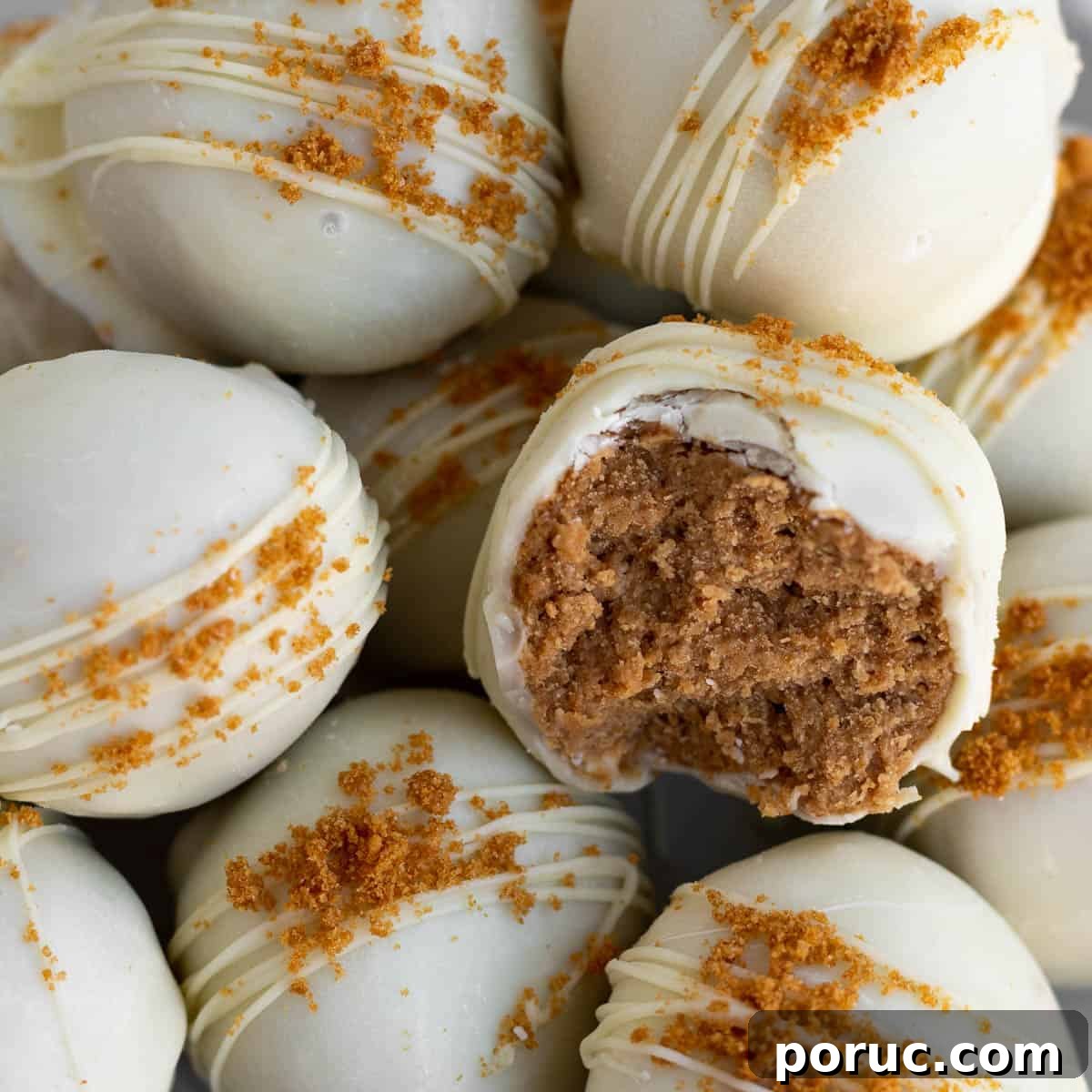 A pile of Biscoff truffles dipped in white chocolate and sprinkled with Biscoff cookie crumbs