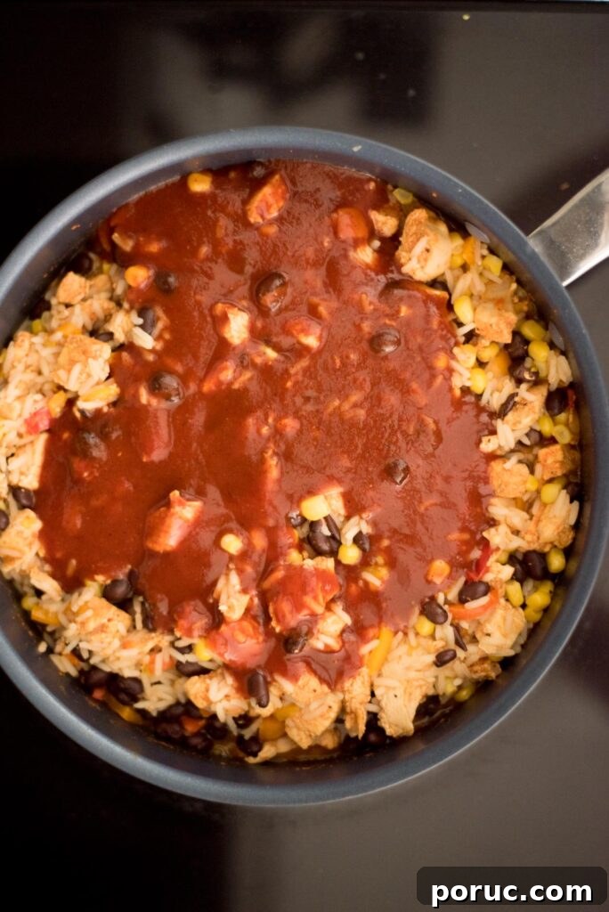 Southwest Chicken Skillet Recipe with Peppers and Black Beans 9 Enchilada sauce added to the skillet with the cooked southwest chicken and rice skillet.