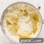Whipped Cotton Candy Cake Recipe for Celebratory Parties 10 fluffy frosting in a stand mixer bowl.