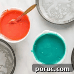 Whipped Cotton Candy Cake Recipe for Celebratory Parties 8 pink and blue cake batter in separate bowls.