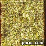 Close up view of a baking sheet with baked parmesan zucchini