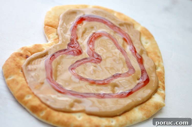 Heart-Shaped Yogurt Flatbread Pizza Recipe for Valentine’s Day 5 Show someone you care with this Peanut Butter and Jelly Heart Flatbread! Serve with apple heart cutouts and cold milk for the perfect lunch on Valentine's Day, back to school or any time of year.
