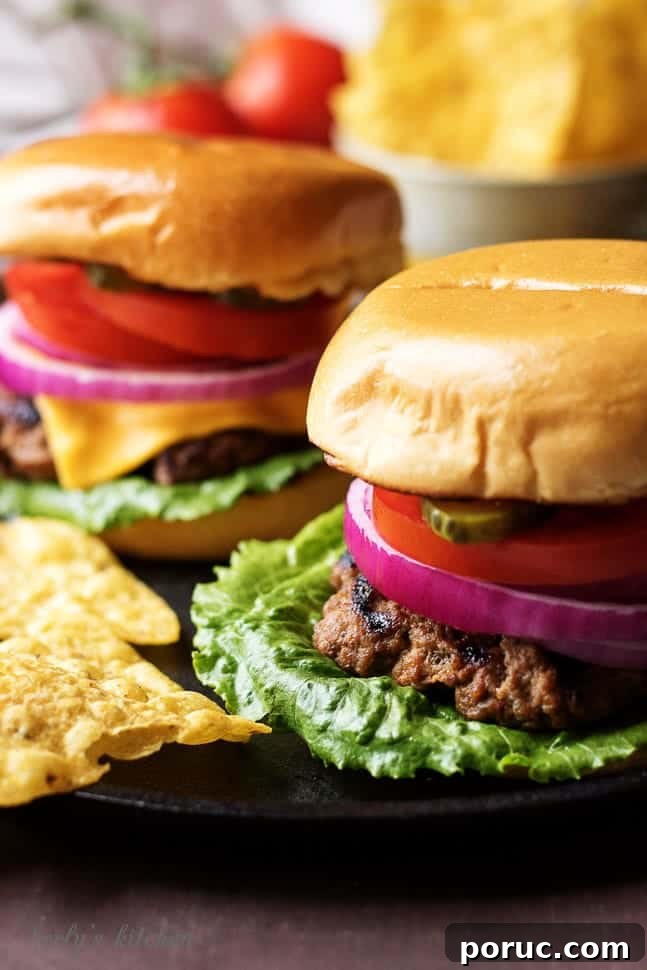 Homemade Hamburger Recipe: Juicy Patties and Perfect Buns 4 Two juicy hamburgers on a skillet with lots of toppings.