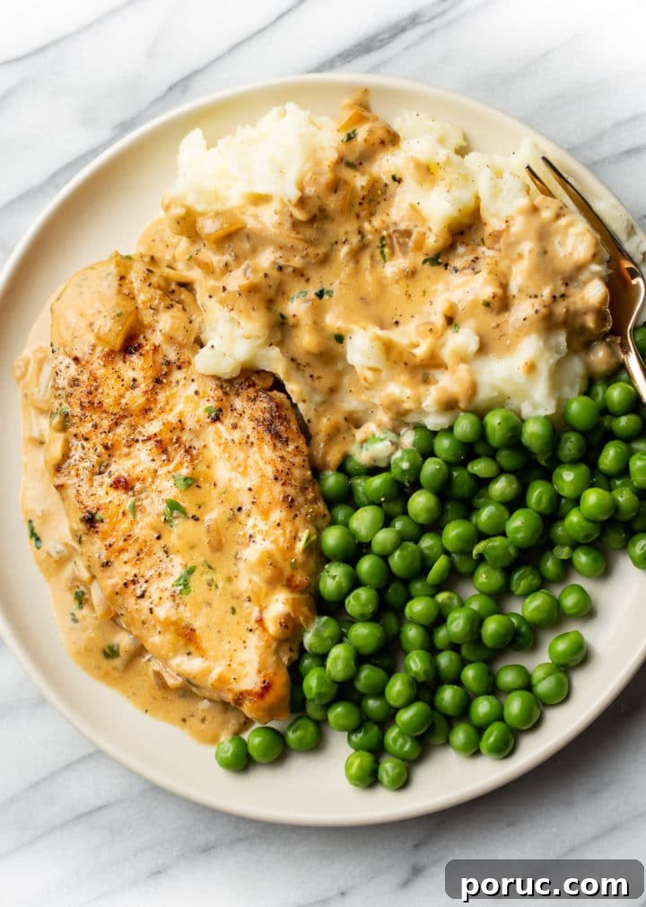 Creamy Boursin Chicken with Garlic and Herbs 2 Boursin chicken plated with peas and mashed potatoes