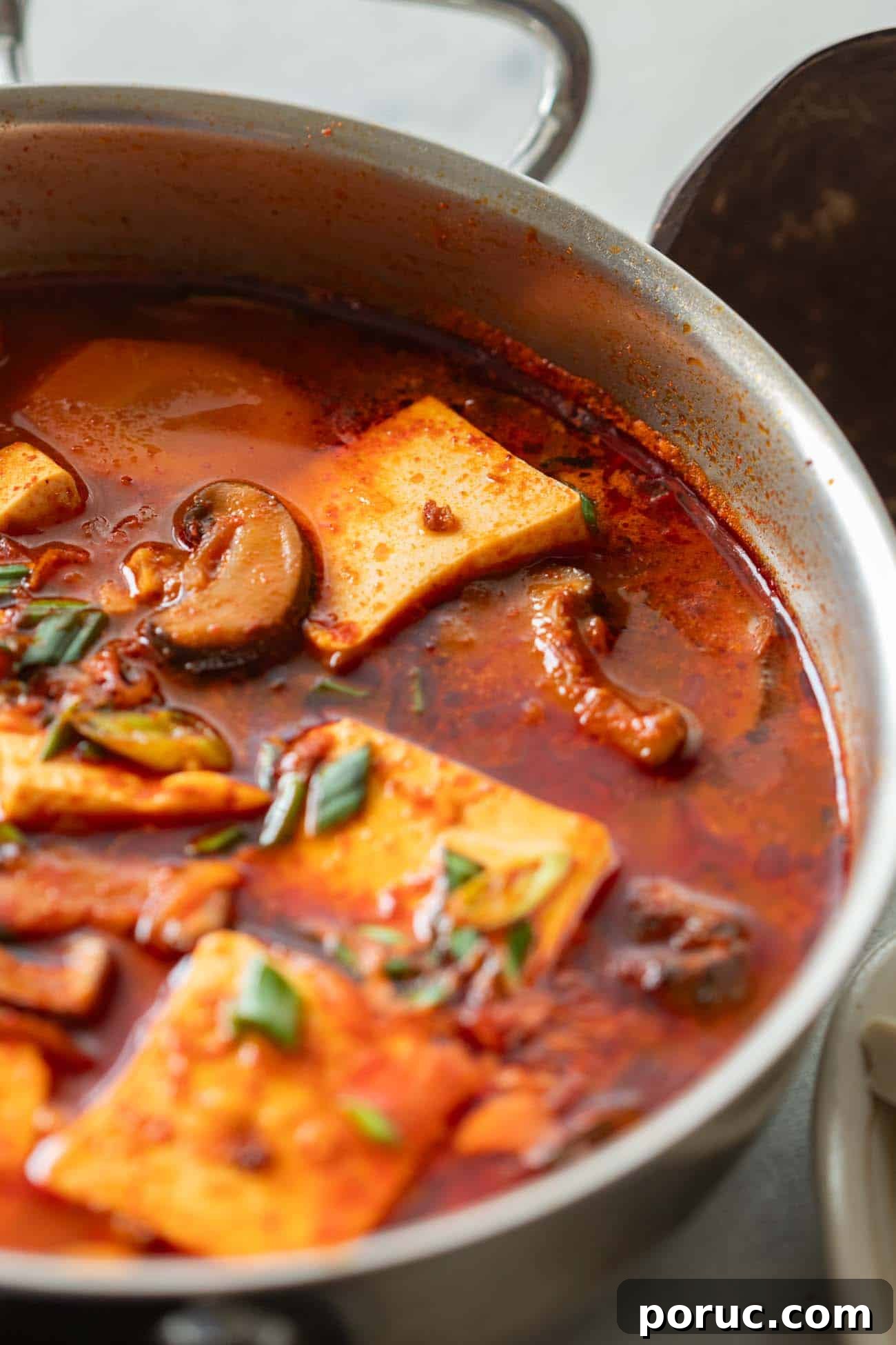 Soondubu Jjigae: Korean Soft Tofu Stew Recipe & Serving Tips 6 korean soft tofu stew in a white bowl