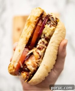 hunters chicken sandwich close up overhead shot of hand holding hunters chicken sandwich above marble background