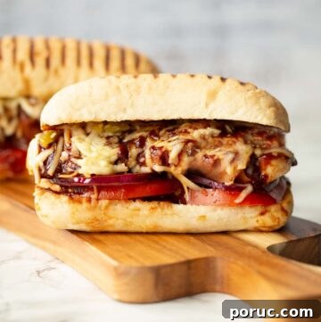2 hunters chicken sandwiches on wooden board with one in front of the other