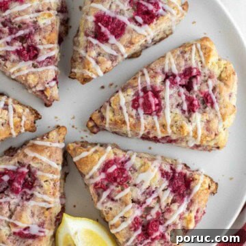 Raspberry lemon scones on plate with lemon.